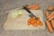 Slicing carrots on wooden cutting board