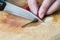 Slicing chilli pepper and knife on wooden bamboo chopping board