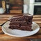 Slicing of chocolate cake, layers that are delicious and melting, side view, warm kitchen