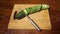 Slicing cucumber. Closeup of chopped vegetables on wooden cutting board. Stop motion animation