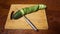 Slicing cucumber. Closeup of chopped vegetables on wooden cutting board. Stop motion animation