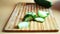 Slicing cucumber with japan chef\'s knife for home side dish preparation.