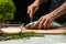 Slicing fish by the chef on a black background