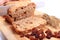 Slicing fresh bread, ears of wheat and raisins