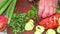 Slicing green parsley with a knife on a cutting board.