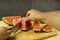 Slicing with a knife a ripe red juicy watermelon.