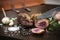 Slicing organic roast beef roll on wood table with ingredients