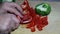 Slicing red pepper and cutting into pieces.