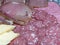 Slicing smoked sausages, dried meat and cheese on a plate. Homemade jerky. Environmentally friendly and natural product.