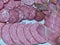 Slicing smoked sausages and dried meat on a plate. Homemade jerky. Environmentally friendly and natural product.