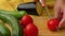 Slicing tomato on chopping board