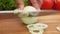 Slicing white onions with knife on the board