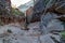 Slick sandstone canyon walls and muddy puddles along the Observation Point hiking trail in Zion National Park