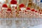 A slide of champagne with dry ice and smoke at the solemn event. Pyramid of glasses with alcohol and cherries.