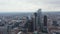 Slide and pan aerial view of group of modern tall office buildings in financial and economic hub in City district