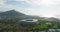 Slide and pan shot of futuristic structure. Modern football stadium surrounded by golf course. Buildings in vacation