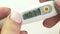 Slide shot of medical digital thermometer in womans hands 40.3 Corona. Covid-19
