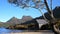 Slider shot of the boat shed at dove lake framed by a gum tree