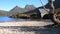 Slider shot of the boat shed and the shore of dove lake framed by a gum tree