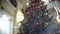 Slider view of red camera balls. New Year`s and abstract blurred shopping mall background with Christmas tree