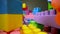 Sliding through the colorful plastic toy building blocks