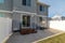 Sliding glass door at the back of a townhouse with white vinyl fence