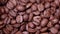 Sliding through Roasted coffee beans. pile of fragrant coffee seeds in Slow Motion. Arabica, Robusta