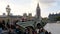 Sliding shot of Big Ben and houses of Parliament during conservation refurbishment, people and traffic on Westeminster Bridge