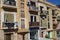 SLIEMA, MALTA - NOVEMBER 5TH 2019 :Traditional multicoloured wooded balcony windows overlook the road in the back streets of Malta