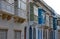 SLIEMA, MALTA - OCTOBER 26TH 2019: Traditional multicoloured wooden balcony windows overlook the road in the back streets of Malta