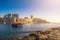 Sliema, Malta - Sunrise with traditional maltese boat and apartments of Tigne point taken from Manoel island