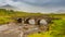 Sligachan bridge by the River Sligachan, on a cloudy summers morning on the Isle of Skye, Scotland, with the Cuillin Mountains i