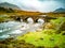 Sligachan Old stone Bridge over River Sligachan with Beinn Dearg Mhor and Marsco peak of Red Cuillin mountains in