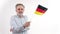 Slightly confused elder gray-haired German man waving his country's flag. The importance of democracy. White