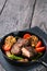 Slightly fried beef steak with vegetables on cast-iron frying pa