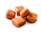 Slightly melted toffee caramel candy close-up isolated with clipping path on white