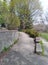 Slightly unkempt garden path and wall dried leaves stone