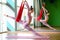 Slim athletic woman in hammock do aerial yoga and stretching exercises. Sport motivation and healthy lifestyle