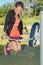 Slim athletic woman make exercises on sporty machine on sports ground in outdoors park