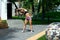 Slim awesome woman with ideal body stretching body on sports ground outdoors