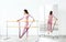 Slim ballerina woman girl in pink tracksuit. Stretching at ballet machine with resistance rubber. Athletic flexibility