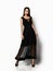 Slim beauty female model in an autumn dark long dress looking at the camera in full body growth