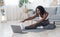 Slim black girl making morning exercise at home