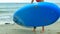Slim blond girl takes rubber paddle board walks to ocean