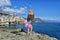 Slim blonde girl in dress with festive pink balloons on a background of the sea on bright sunny days. Crimea, Utes