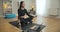 Slim concentrated yogi sitting in lotus pose on exercise mat and closing eyes. Portrait of beautiful calm Caucasian