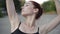 Slim confident ballet woman performing outdoors. Camera moves up along slender Caucasian ballerina moving hands