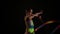 Slim cute attractive little girl athlete in bright colorful swimsuit performs elements of rhythmic gymnastics with ribbon