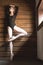 Slim dancer stands on one leg in a ballet pose