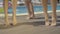 Slim female legs dancing on wooden platform next to swimming pool. Four unrecognizable slender Caucasian women enjoying